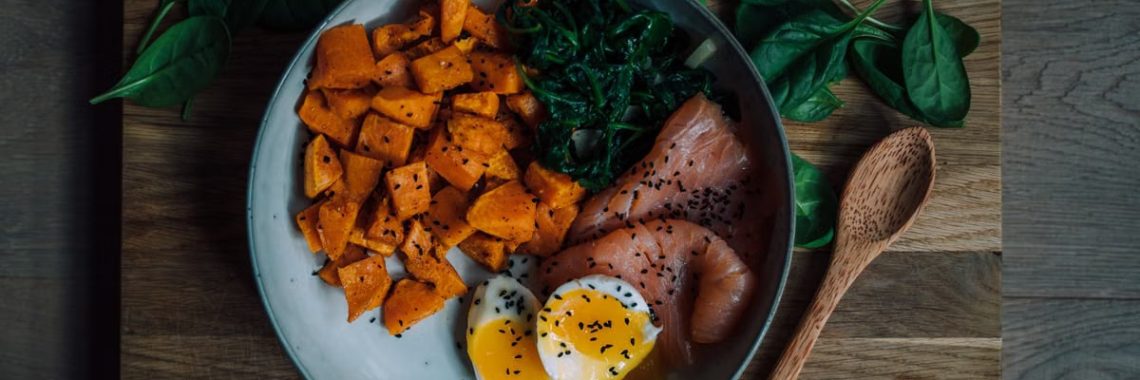 Delicious and nutritious meal featuring salmon, sweet potato, and eggs, perfect for a healthy diet.